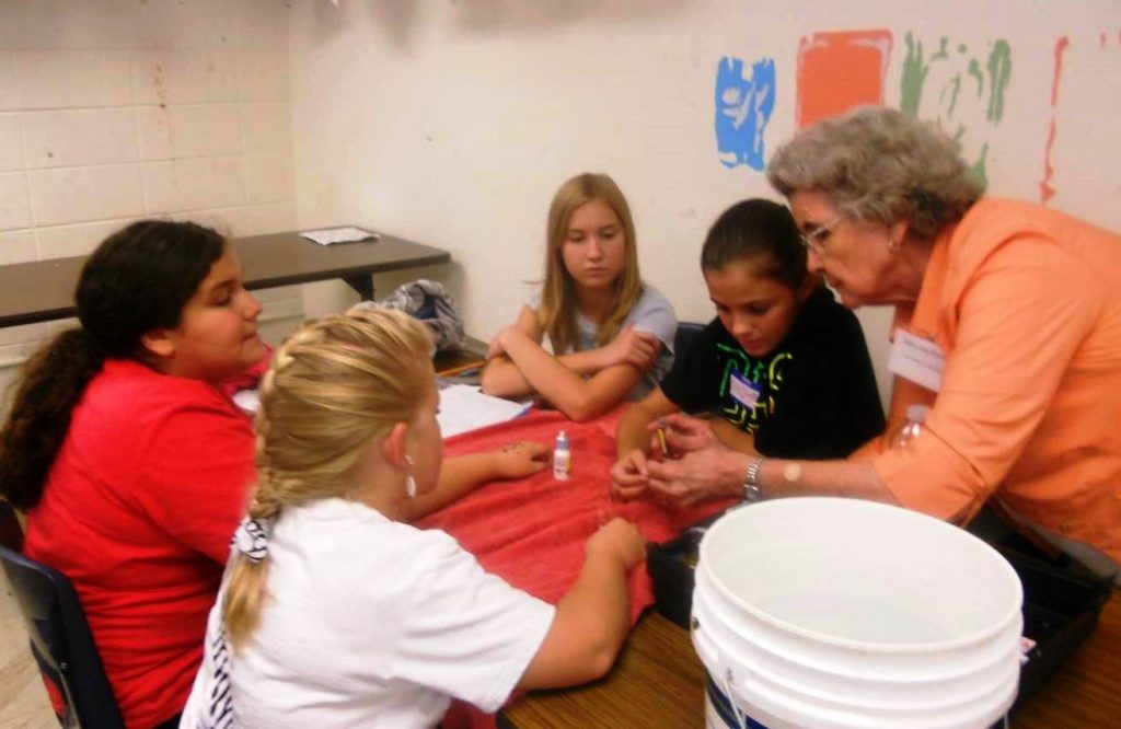 Mary Ann instructing students at Radney Elementary School in Alexander City how to monitor for bacteria.
