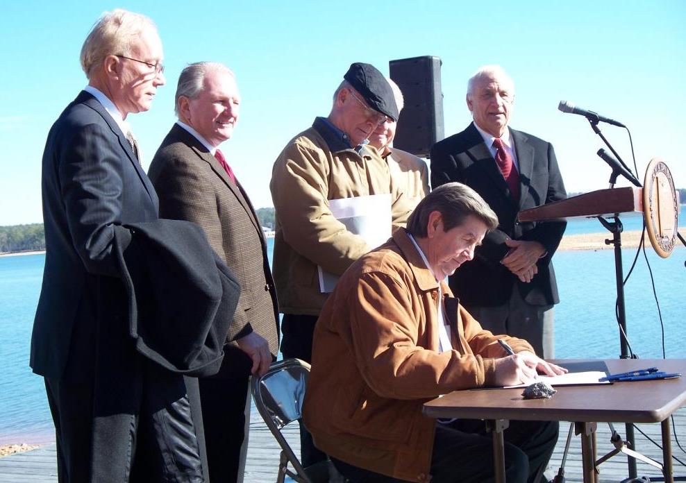 Dick Bronson witnessing Governor Bob Riley signing Executive Order 52, establishing the Treasured Alabama Lake (TAL) at Children’s Harbor on Lake Martin in December 2010.