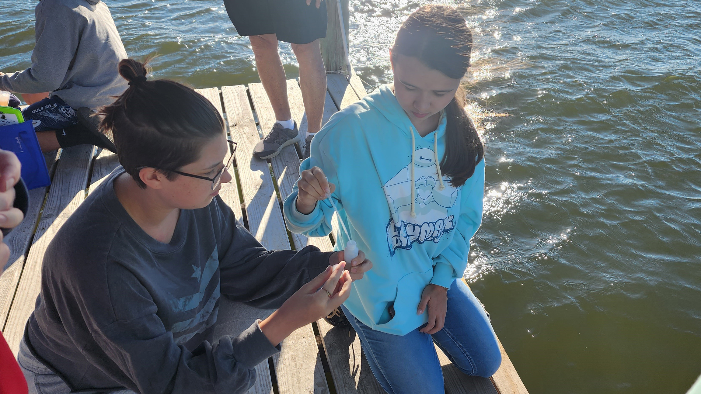 Gulf Shores High School Students collect a sample for bacteriological monitoring. 