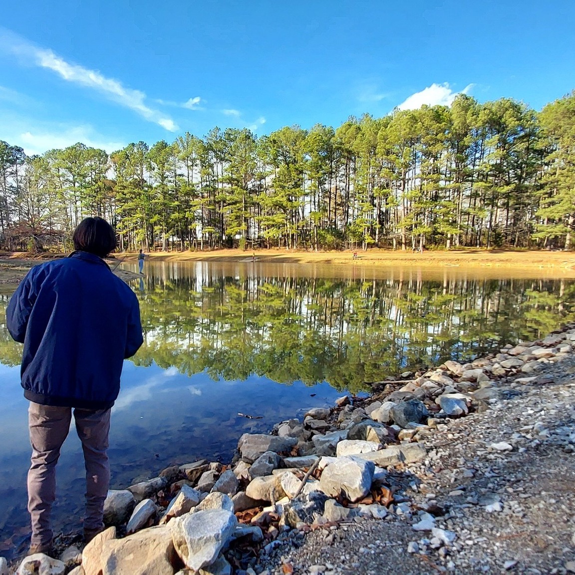 Man looks out over a lake